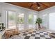 Sunroom area with a wood ceiling, a tiled floor and many windows to the backyard at 3219 Centerwood Dr, Tarpon Springs, FL 34688