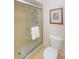 Bathroom with a glass shower enclosure and updated toilet at 322 Windrush Loop # 22, Tarpon Springs, FL 34689