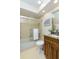 The bathroom has a shower and tub combination with glass doors, as well as a vanity with ample storage space at 322 Windrush Loop # 22, Tarpon Springs, FL 34689