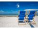 Blue beach chairs on sandy beach with ocean view at 322 Windrush Loop # 22, Tarpon Springs, FL 34689