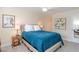 Comfortable bedroom featuring a plush bed with blue comforter and neutral decor at 322 Windrush Loop # 22, Tarpon Springs, FL 34689