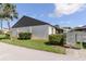 This building features well-maintained landscaping and a light-colored exterior at 322 Windrush Loop # 22, Tarpon Springs, FL 34689