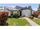 Well-maintained single-story home with a neatly manicured lawn and walkway at 322 Windrush Loop # 22, Tarpon Springs, FL 34689
