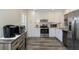 Modern kitchen with stainless steel appliances, ample counter space, and white cabinets at 322 Windrush Loop # 22, Tarpon Springs, FL 34689