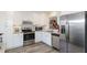 Modern kitchen with stainless steel appliances, white cabinets, and granite countertops at 322 Windrush Loop # 22, Tarpon Springs, FL 34689