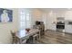 Kitchen and dining area with views of the stainless steel appliances and white cabinets at 322 Windrush Loop # 22, Tarpon Springs, FL 34689