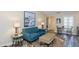 Comfortable living room featuring a blue sofa and stylish décor at 322 Windrush Loop # 22, Tarpon Springs, FL 34689