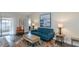 Comfortable living room with a blue couch, decorative rug, and plenty of natural light at 322 Windrush Loop # 22, Tarpon Springs, FL 34689