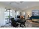 Bright and open office space leading to a living room and covered patio at 322 Windrush Loop # 22, Tarpon Springs, FL 34689