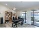Bright office with ample light, ceiling fan, and sliding glass doors to patio at 322 Windrush Loop # 22, Tarpon Springs, FL 34689