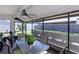 Screened-in porch with seating and views of the backyard and greenery around the home at 322 Windrush Loop # 22, Tarpon Springs, FL 34689