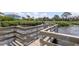 Elevated wooden walkway provides a picturesque view of the bay and surrounding landscaping at 322 Windrush Loop # 22, Tarpon Springs, FL 34689