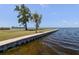 Scenic waterfront with a seawall and benches overlooking the water at 322 Windrush Loop # 22, Tarpon Springs, FL 34689