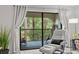 Screened-in balcony with a comfortable chair, offering serene views of the surrounding greenery at 3399 Mermoor Dr # 301, Palm Harbor, FL 34685