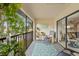 Relaxing screened balcony with plants and seating, perfect for enjoying the outdoor scenery at 3399 Mermoor Dr # 301, Palm Harbor, FL 34685