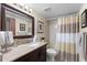 Bathroom features a vanity, toilet and shower/tub combo with a brown and white shower curtain at 3399 Mermoor Dr # 301, Palm Harbor, FL 34685