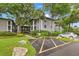 Well-maintained condo building with landscaped grounds, palm trees, and accessible parking, offering a welcoming curb appeal at 3399 Mermoor Dr # 301, Palm Harbor, FL 34685