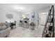 Open concept living space with bar seating connecting the kitchen and white tile flooring at 3399 Mermoor Dr # 301, Palm Harbor, FL 34685