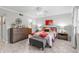 This main bedroom boasts a ceiling fan, dresser, bench, and a queen bed with floral comforter at 3399 Mermoor Dr # 301, Palm Harbor, FL 34685