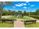 Well-maintained playground with slide, swings, and climbing structure, next to tennis courts at 3399 Mermoor Dr # 301, Palm Harbor, FL 34685