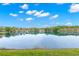 Scenic view of a tranquil pond reflecting the clear blue sky and lush greenery surrounding the community at 3399 Mermoor Dr # 301, Palm Harbor, FL 34685