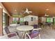 Poolside lounge area features tables, chairs, multiple ceiling fans, and views of the pool at 3399 Mermoor Dr # 301, Palm Harbor, FL 34685