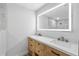 Bathroom featuring a double vanity, wood cabinets, and a large LED mirror at 3910 W Iowa Ave, Tampa, FL 33616