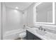 Chic bathroom features a modern vanity with marble countertop and a shower-tub combo at 3910 W Iowa Ave, Tampa, FL 33616