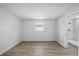 Clean bedroom featuring wood-look flooring, a window, and an ensuite bathroom at 3910 W Iowa Ave, Tampa, FL 33616