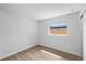 Cozy bedroom features neutral walls, wood-look tile flooring, and natural light at 3910 W Iowa Ave, Tampa, FL 33616
