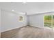 Bright bedroom with a ceiling fan, hardwood floors and sliding glass door to backyard at 3910 W Iowa Ave, Tampa, FL 33616