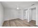 Spacious bedroom with neutral walls, wood-look tile flooring, and a ceiling fan at 3910 W Iowa Ave, Tampa, FL 33616