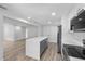 Modern kitchen featuring white cabinets, gray island and stainless steel appliances at 3910 W Iowa Ave, Tampa, FL 33616