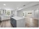 Bright, open kitchen featuring a large island, white cabinets, and stainless steel appliances at 3910 W Iowa Ave, Tampa, FL 33616