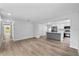 Open-concept living room with hardwood floors and a modern kitchen at 3910 W Iowa Ave, Tampa, FL 33616