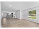 Open-concept living room with hardwood floors and an attached modern kitchen at 3910 W Iowa Ave, Tampa, FL 33616