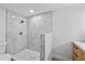 Modern shower features neutral tile, a rainfall shower head, and a sleek glass enclosure at 3910 W Iowa Ave, Tampa, FL 33616