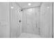 Modern shower features black and white tile, a rainfall shower head, and a built-in bench at 3910 W Iowa Ave, Tampa, FL 33616