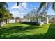 Spacious, landscaped backyard with privacy fence, mature trees, and a glimpse of the home's exterior at 4103 W Bay Villa Ave, Tampa, FL 33611