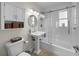 Clean bathroom with a shower-tub, pedestal sink, and medicine cabinet at 4103 W Bay Villa Ave, Tampa, FL 33611
