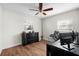 Functional bedroom with wood-look floors, ceiling fan, and desk space for work or study at 4103 W Bay Villa Ave, Tampa, FL 33611
