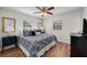 Comfortable bedroom with a ceiling fan, two windows, and a beautifully decorated queen-size bed at 4103 W Bay Villa Ave, Tampa, FL 33611