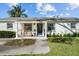 Inviting front entrance with a bench and walkway leading to the vibrant blue front door at 4103 W Bay Villa Ave, Tampa, FL 33611