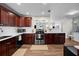 Stylish kitchen with stainless steel appliances, dark wood cabinets, and modern countertops at 4103 W Bay Villa Ave, Tampa, FL 33611