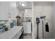 A well-equipped laundry room with modern appliances, storage cabinets, and essential cleaning supplies at 4103 W Bay Villa Ave, Tampa, FL 33611