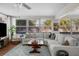 Bright living room with ample windows, a large sectional sofa, and a cozy atmosphere at 4103 W Bay Villa Ave, Tampa, FL 33611