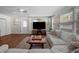Comfortable living room with wood floors, white walls, and a large sectional sofa at 4103 W Bay Villa Ave, Tampa, FL 33611
