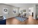 Cozy living room featuring wood-look floors, a decorative rug, and natural light from the front door and window at 4103 W Bay Villa Ave, Tampa, FL 33611
