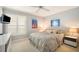 Well-lit bedroom featuring neutral walls, plush carpeting, and a ceiling fan for added comfort at 4138 Saltwater Blvd, Tampa, FL 33615