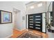 Inviting foyer features a high ceiling, clerestory windows, and modern black double doors with horizontal glass inserts at 4138 Saltwater Blvd, Tampa, FL 33615